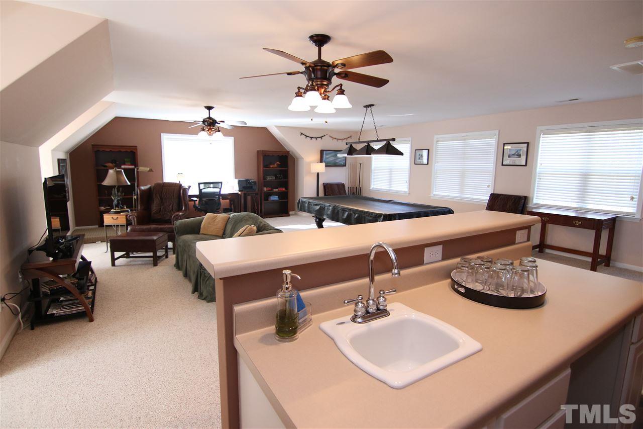 5976 Elevation Road Benson, NC 27504 - Photo 18 of 25 a living room with furniture and a chandelier
