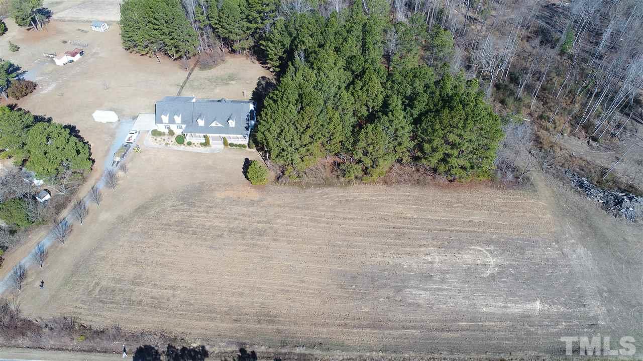 5976 Elevation Road Benson, NC 27504 - Photo 3 of 25 a view of a yard with plants and trees