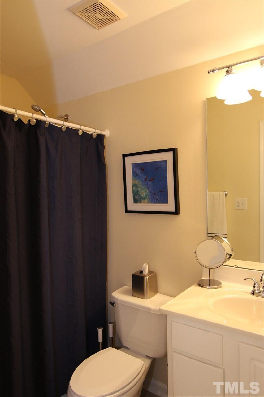5976 Elevation Road Benson, NC 27504 - Photo 21 of 25 a bathroom with a granite countertop sink mirror vanity and toilet