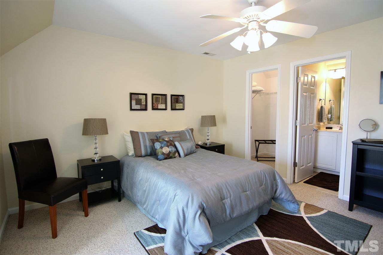 5976 Elevation Road Benson, NC 27504 - Photo 22 of 25 a bedroom with a bed and a chair
