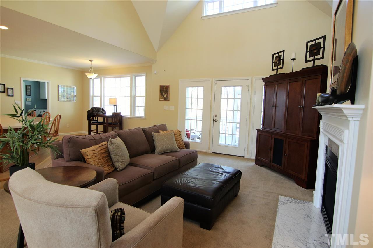 5976 Elevation Road Benson, NC 27504 - Photo 5 of 25 a living room with furniture a flat screen tv and a refrigerator