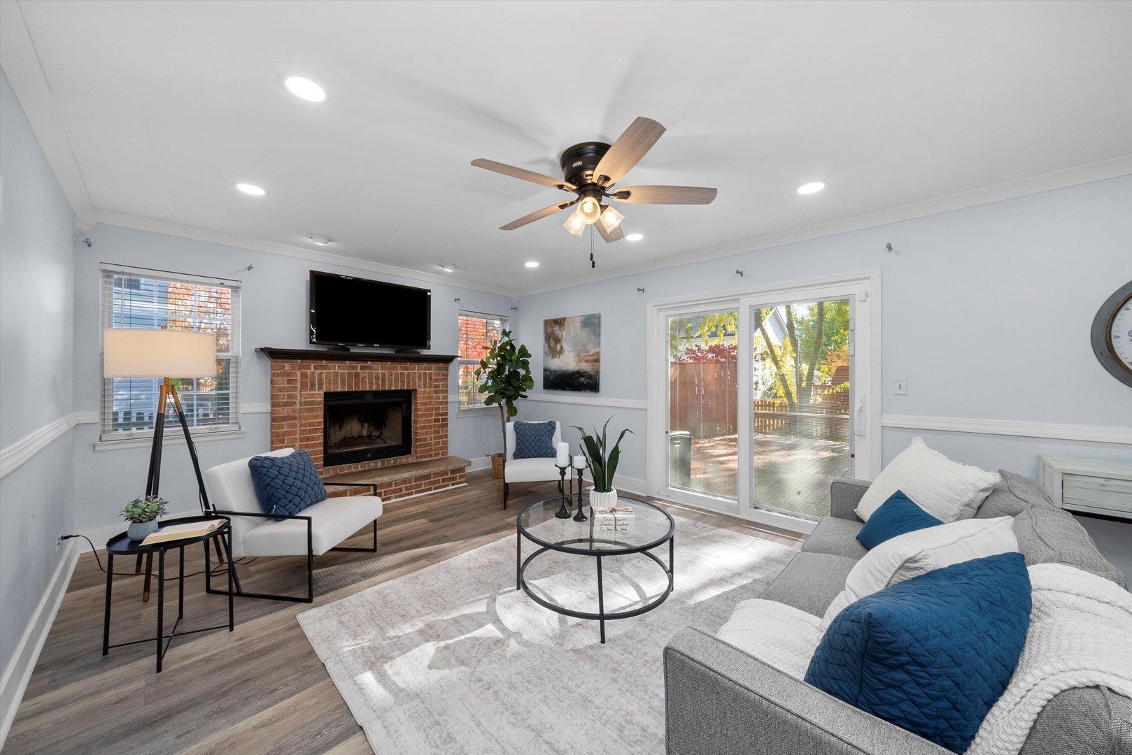 167 Forestview Court Aurora, IL 60502 - Photo 12 of 48 a living room with furniture a fireplace and a flat screen tv