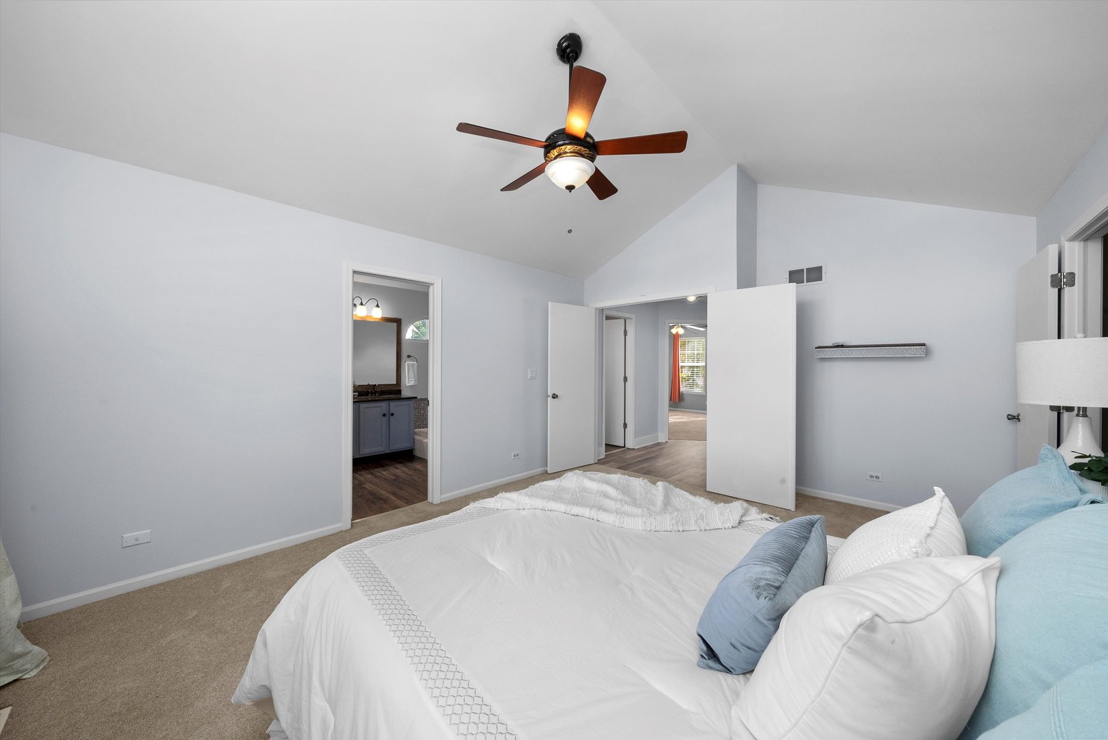 167 Forestview Court Aurora, IL 60502 - Photo 18 of 48 a bedroom with a large bed and a chandelier