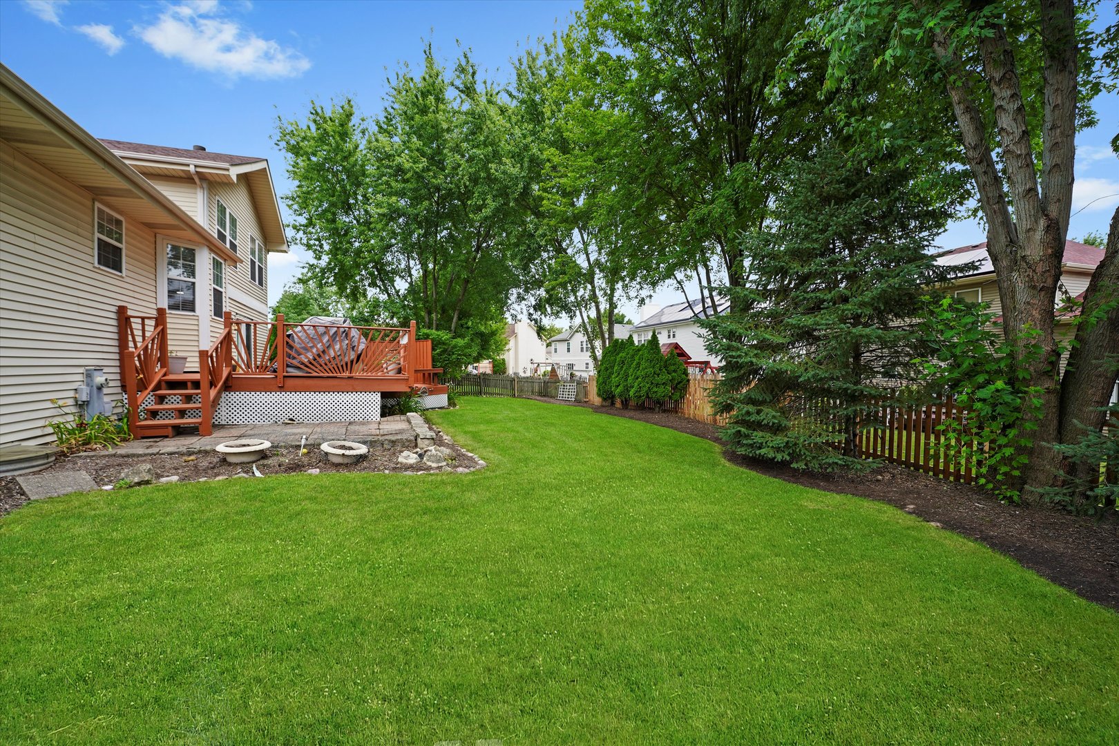 167 Forestview Court Aurora, IL 60502 - Photo 38 of 48 a view of a backyard with table and chairs a barbeque and a large tree