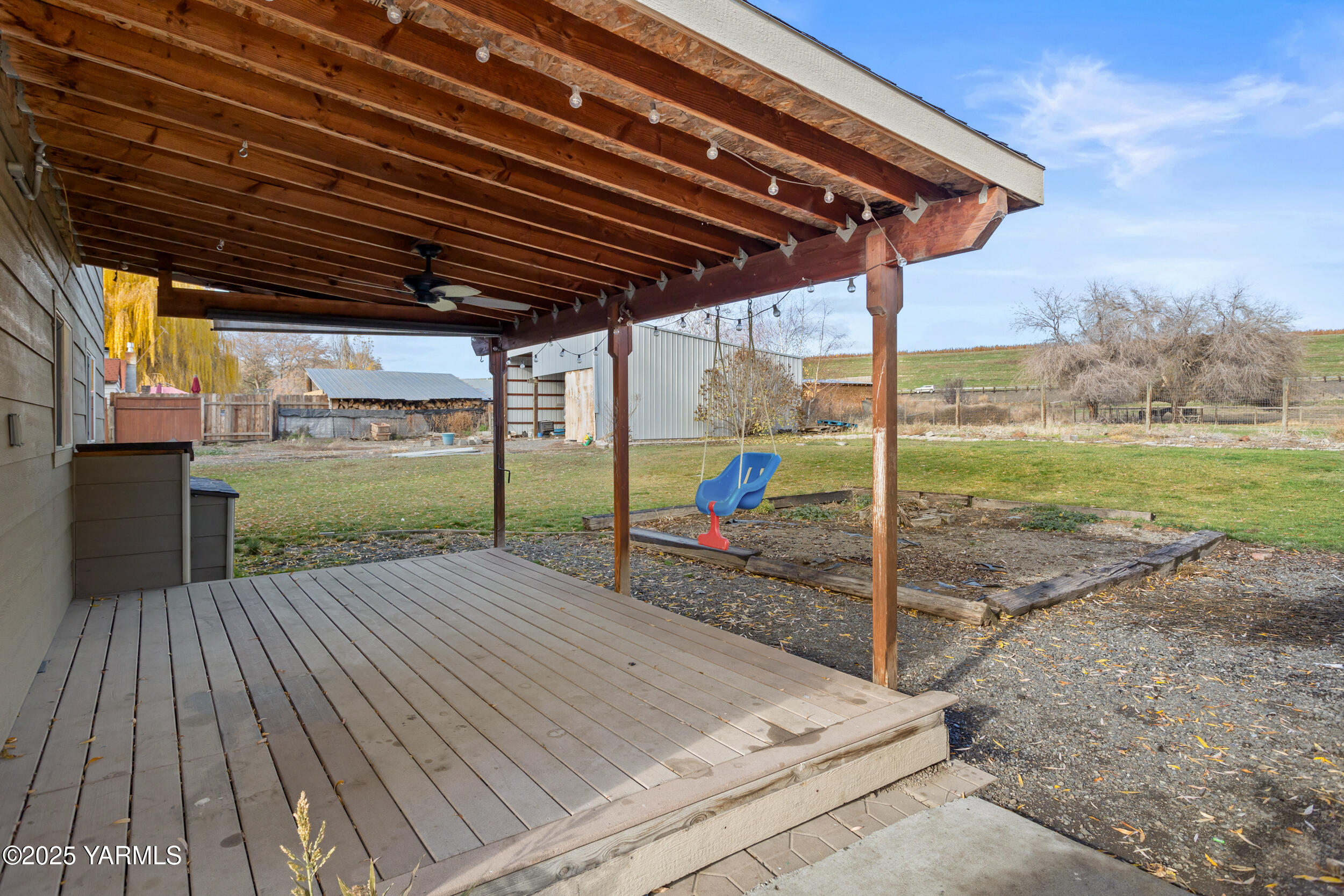 11501 Gilbert Road Yakima, WA 98903 - Photo 35 of 47 a view of a backyard with wooden floor and floor to ceiling window