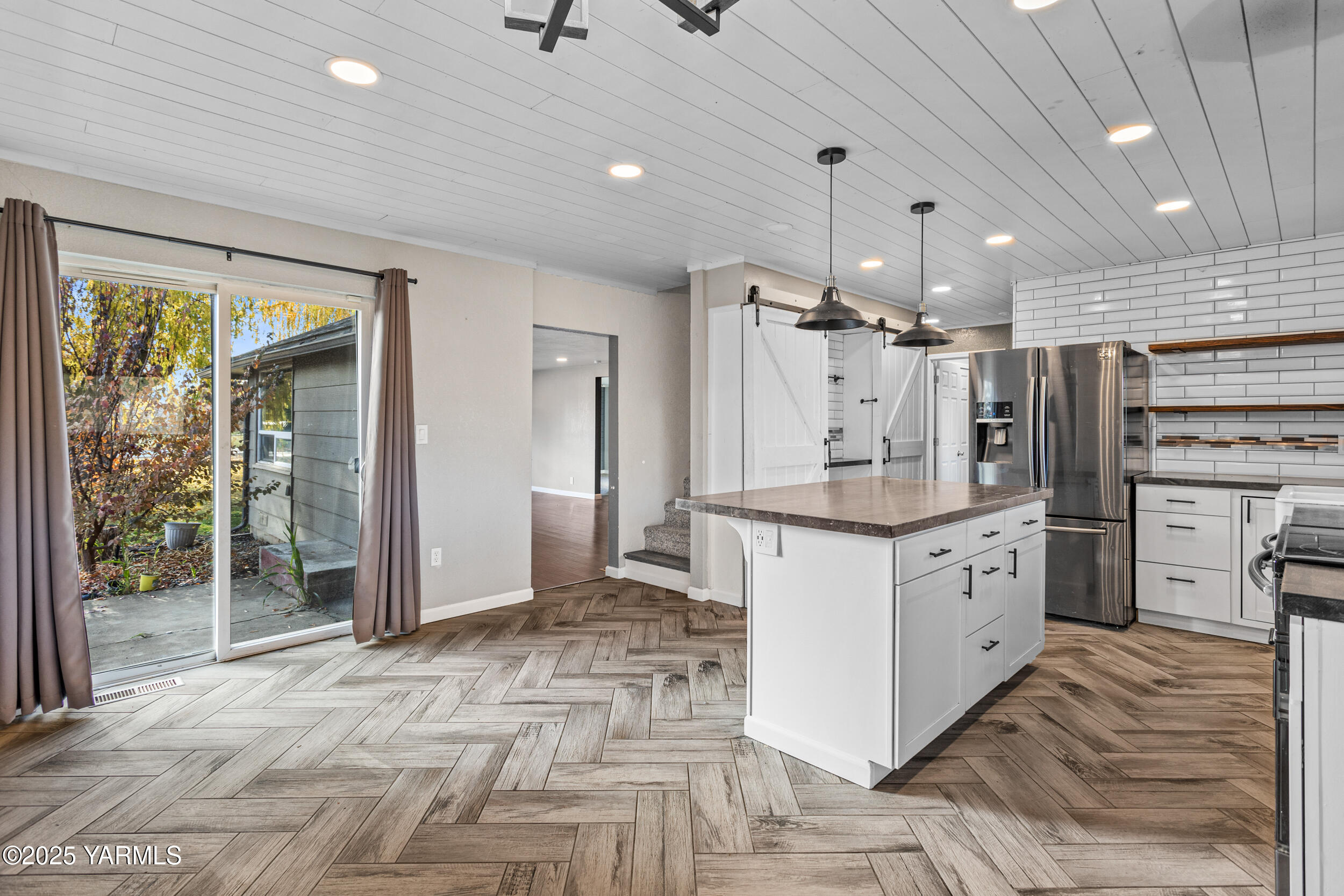 11501 Gilbert Road Yakima, WA 98903 - Photo 40 of 47 a kitchen with granite countertop a refrigerator oven a sink dishwasher and white cabinets next to a window