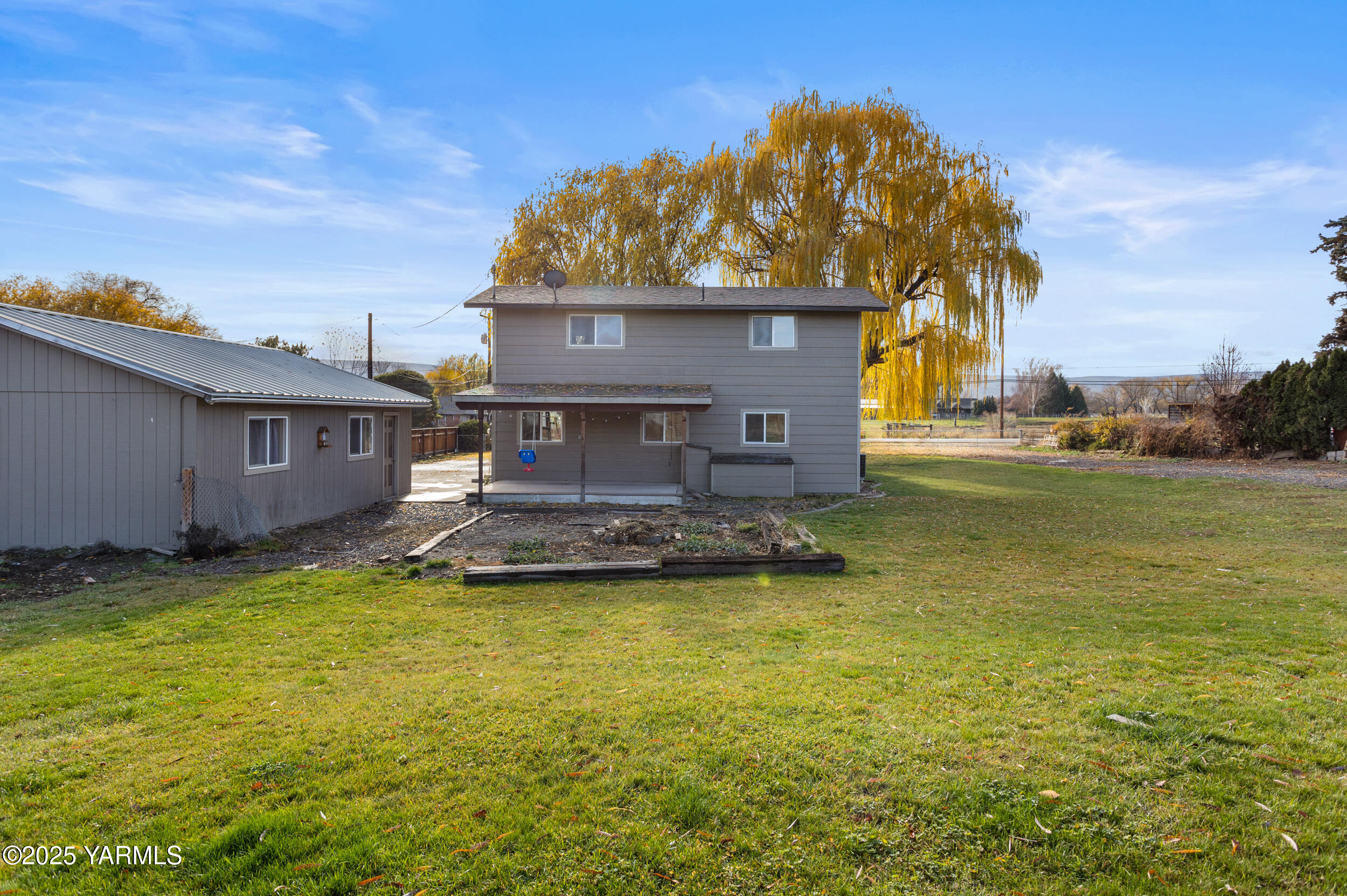 11501 Gilbert Road Yakima, WA 98903 - Photo 45 of 47 a view of a house with a yard balcony and a tree
