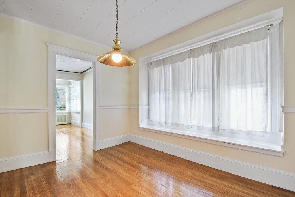 22 Kendall Road Lexington, MA 02421 - Photo 8 of 24 a view of an empty room with wooden floor and a window