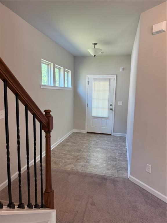 149 Hardy Water Drive Southeast Lawrenceville, GA 30045 - Photo 4 of 5 a view of an empty room with wooden floor and stairs