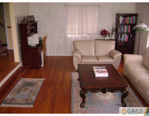 751 New Dover Road Edison, NJ 08820 - Photo 3 of 10 a living room with furniture and a book shelf