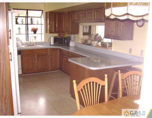 751 New Dover Road Edison, NJ 08820 - Photo 4 of 10 a kitchen with a sink cabinets and window