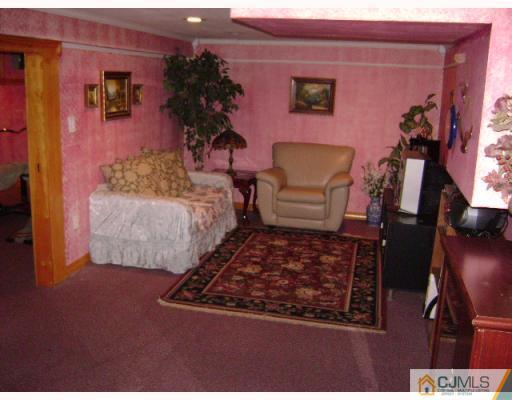 751 New Dover Road Edison, NJ 08820 - Photo 7 of 10 a living room with furniture rug and lamp