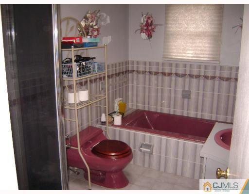 751 New Dover Road Edison, NJ 08820 - Photo 8 of 10 a bathroom with a bathtub and a shower