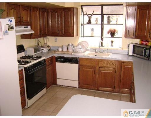751 New Dover Road Edison, NJ 08820 - Photo 9 of 10 a kitchen with stainless steel appliances granite countertop a stove a sink and a microwave
