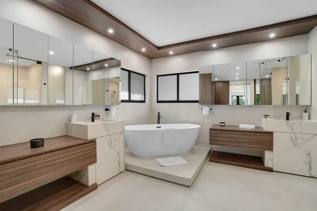 a bathroom with a bathtub a sink a mirror and a bathtub