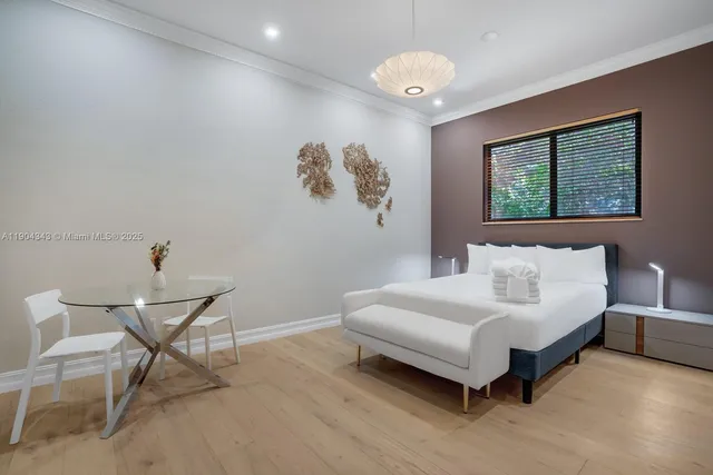 a spacious bedroom with a bed and a window