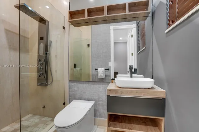 a bathroom with a sink toilet and shower