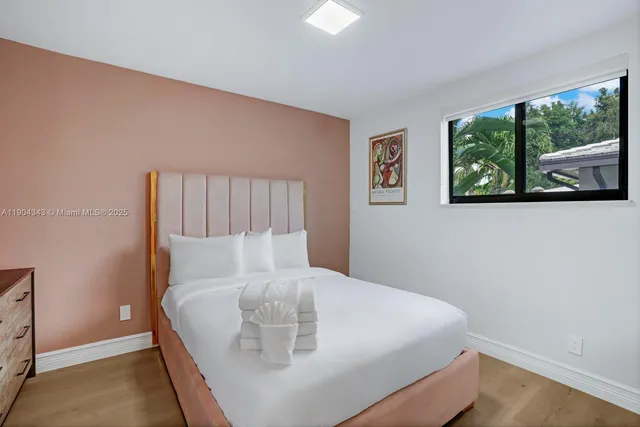 a bed sitting in a bedroom next to a window