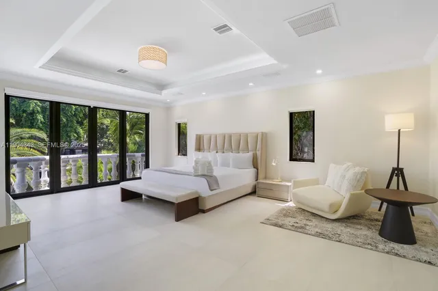 a spacious bedroom with a bed and large window