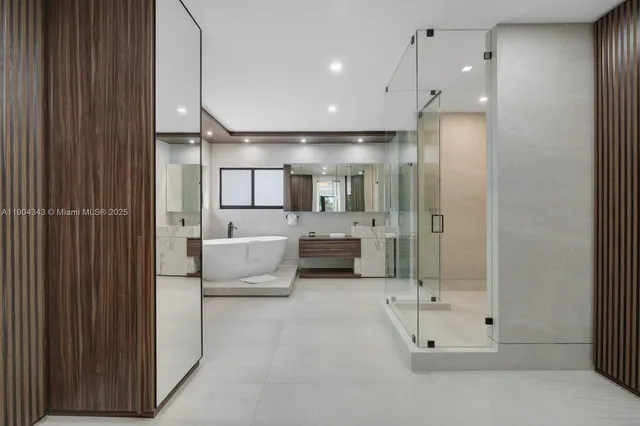 a bathroom with a large tub shower and sink