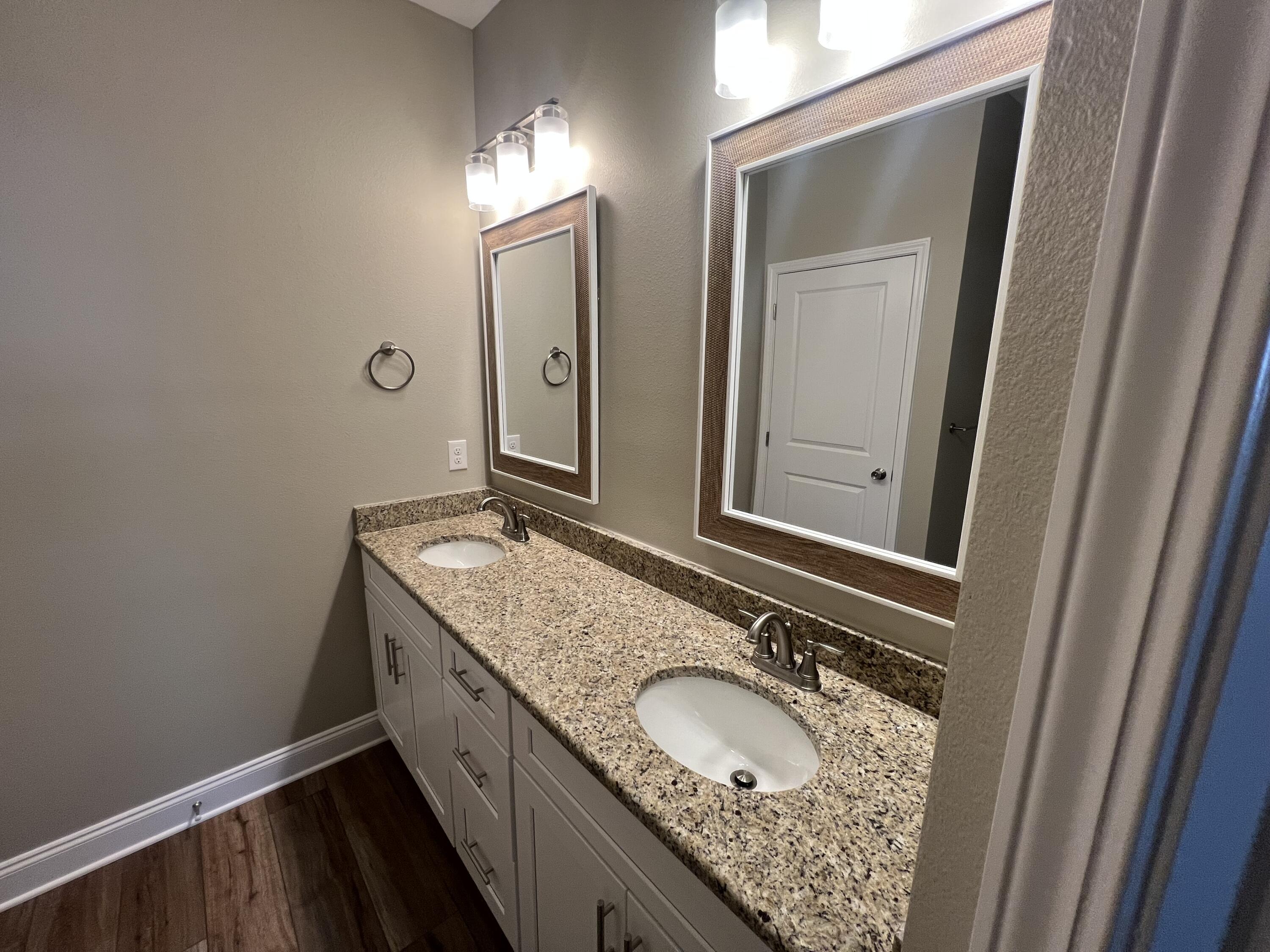 89 Hawkins Road Fort Walton Beach, FL 32547 - Photo 8 of 12 a bathroom with a granite countertop sink and a mirror