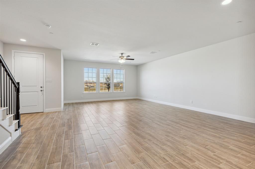 6028 Bursey Road Watauga, TX 76148 - Photo 4 of 27 wooden floor in an empty room with a window