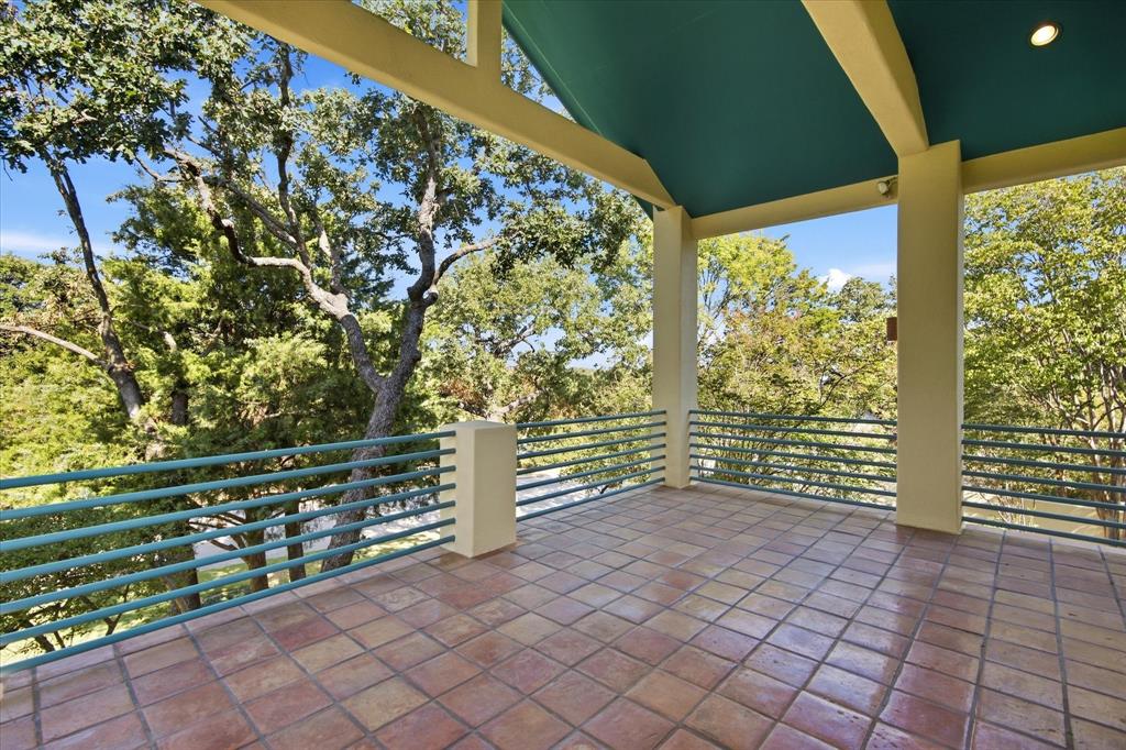 3606 Labrador Grapevine, TX 76051 - Photo 13 of 38 Expansive outdoor balcony featuring terracotta tile flooring, a sloped ceiling with recessed lighting, sturdy support columns, and an extensive metal railing