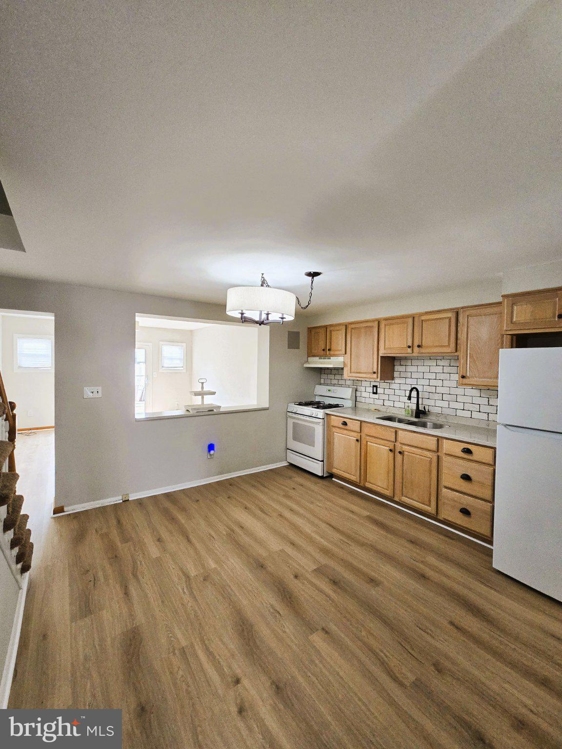 7842 St Bridget Lane Baltimore, MD 21222 - Photo 4 of 13 a view of a kitchen with wooden floor
