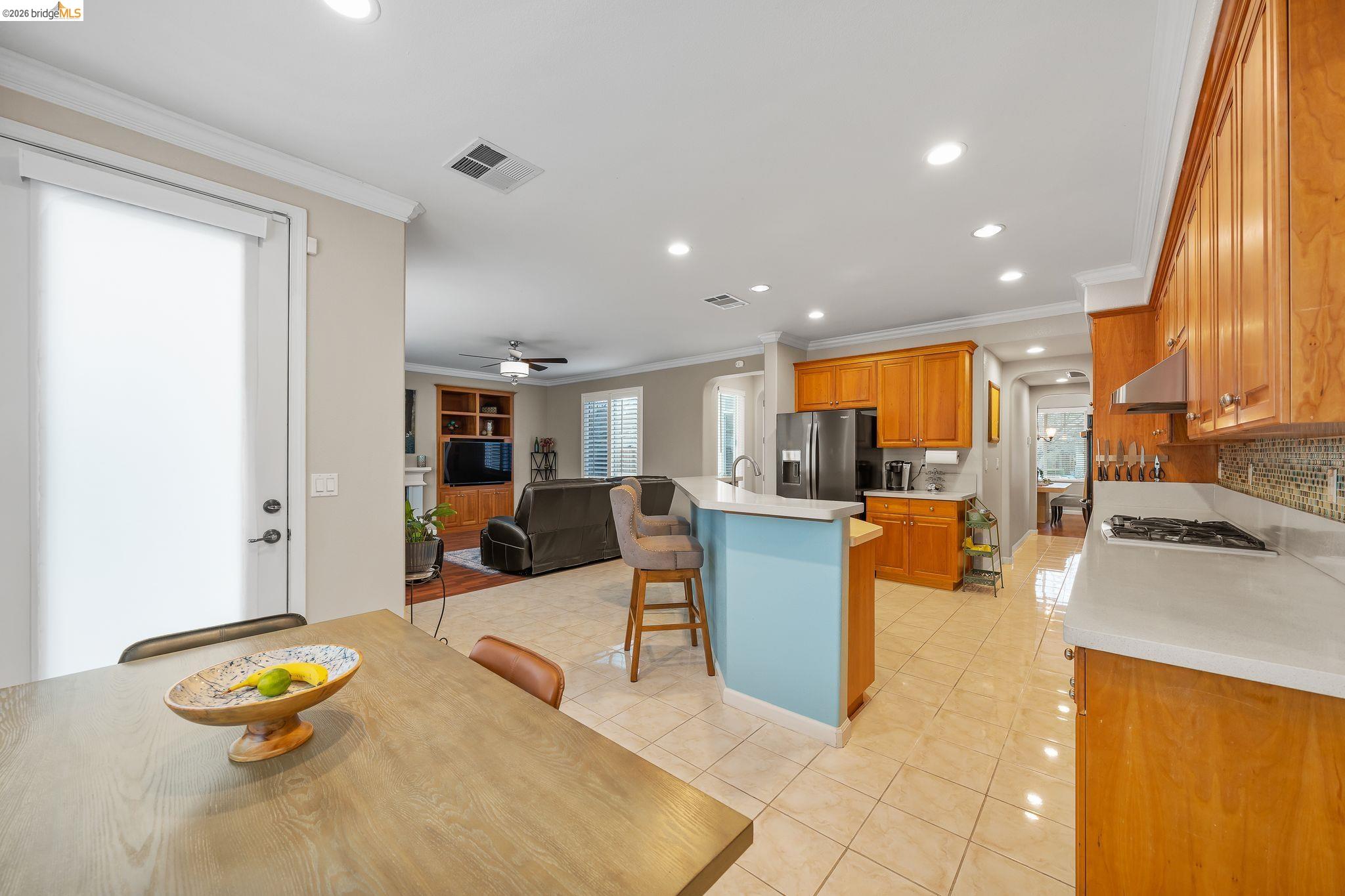 3237 Oso Grande Way Antioch, CA 94531 - Photo 46 of 47 Kitchen with a breakfast bar, open floor plan, recessed lighting, wood finish cabinetry, and light tile patterned flooring