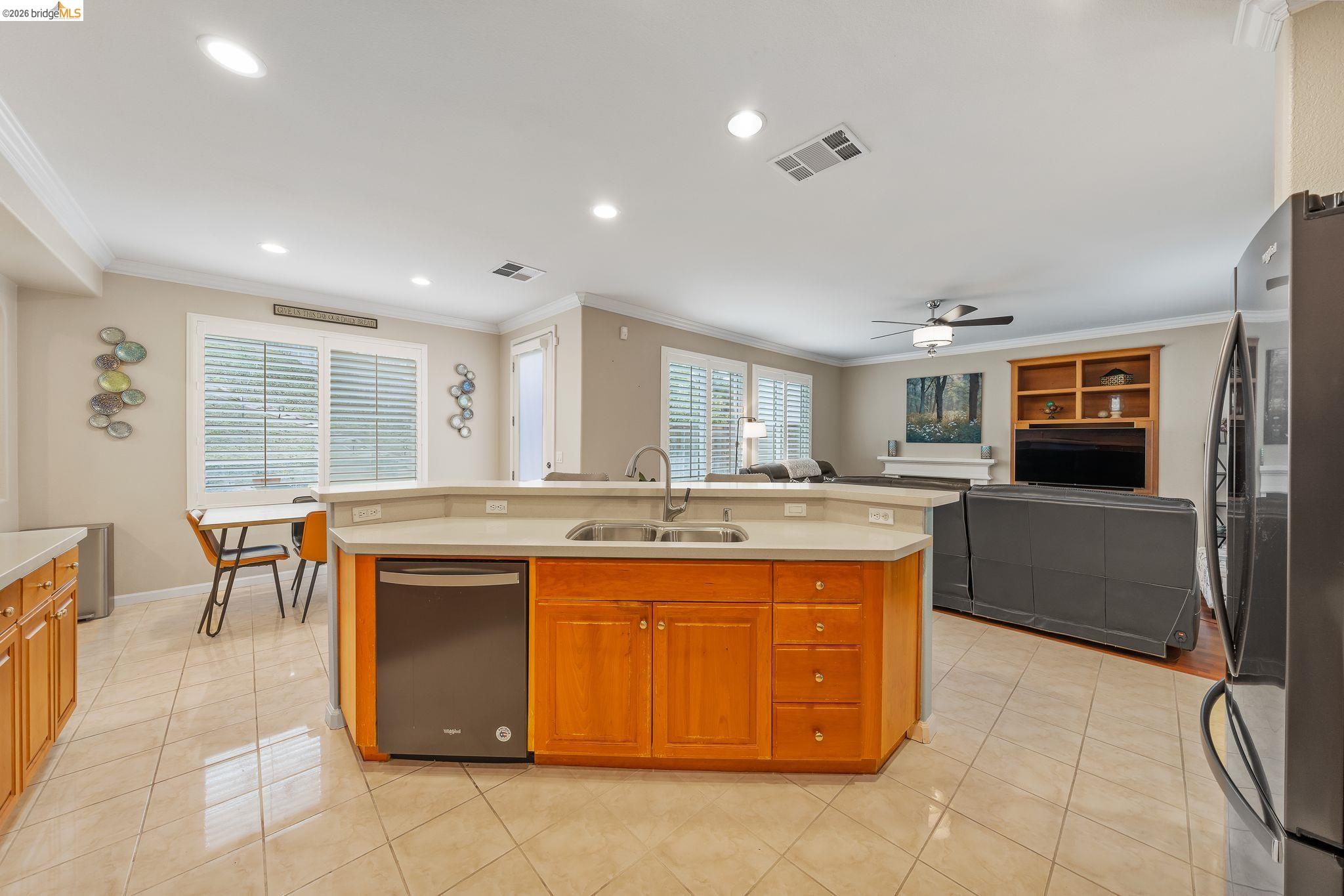 3237 Oso Grande Way Antioch, CA 94531 - Photo 47 of 47 Kitchen featuring an island with sink, stainless steel appliances, open floor plan, light tile patterned floors, and light countertops