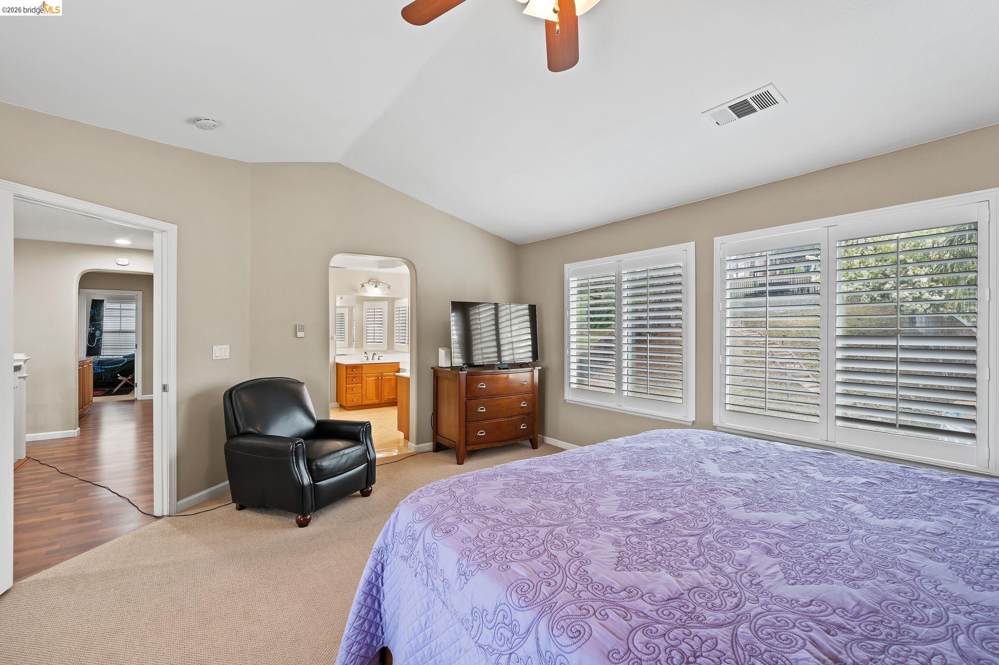 3237 Oso Grande Way Antioch, CA 94531 - Photo 25 of 47 Bedroom with arched walkways, vaulted ceiling, light carpet, a ceiling fan, and ensuite bathroom