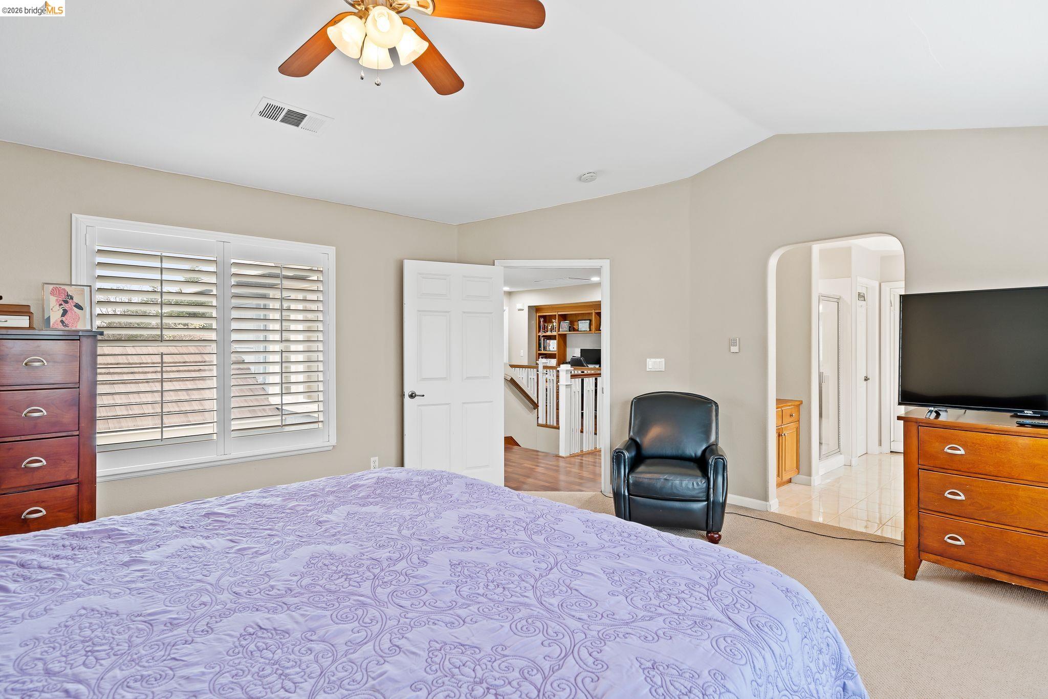 3237 Oso Grande Way Antioch, CA 94531 - Photo 36 of 47 Bedroom featuring lofted ceiling, ceiling fan, light colored carpet, and arched walkways