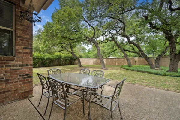 a backyard of a house with table and chairs