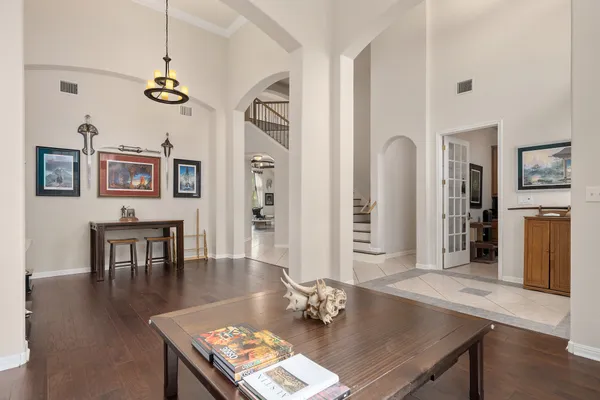 a living room with furniture wooden floor and a chandelier