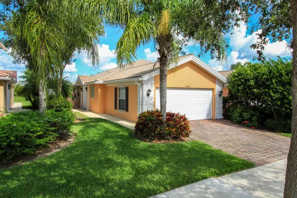 a view of backyard with a garden and palm trees