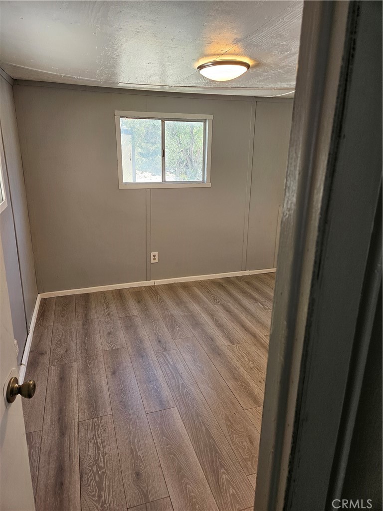 2801-road Johnson Road, Unit 17 Frazier Park, CA 93225 - Photo 6 of 6 an empty room with wooden floor and windows