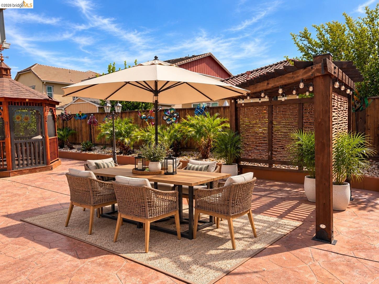 809 Ibis Road Oakley, CA 94561 - Photo 18 of 32 Stained concrete patio with a wooden pergola, privacy screen, and built-in landscape beds