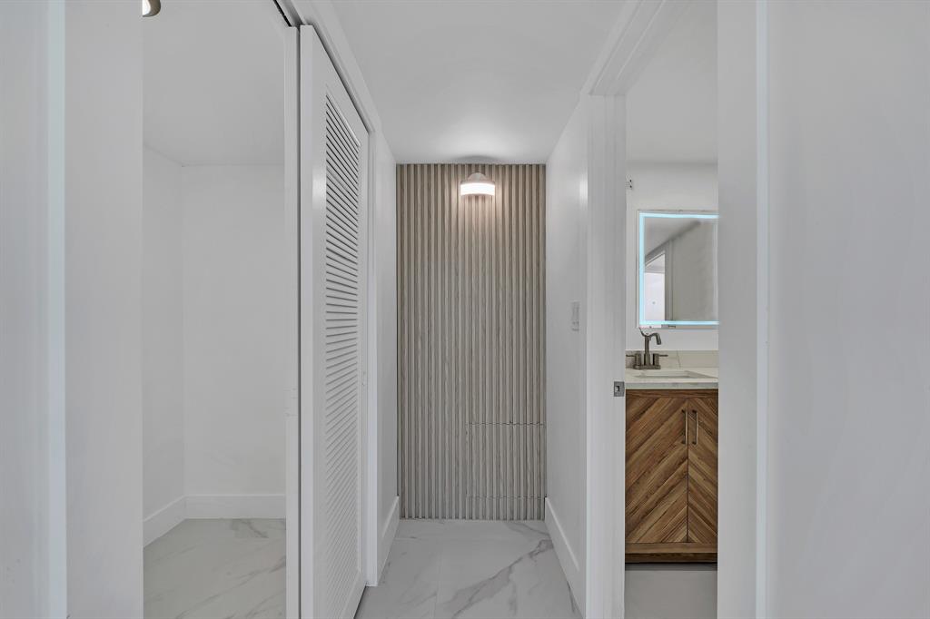 9818 Marina Boulevard, Unit 1225 Boca Raton, FL 33428 - Photo 14 of 17 a view of a hallway with wooden floor windows and entryway