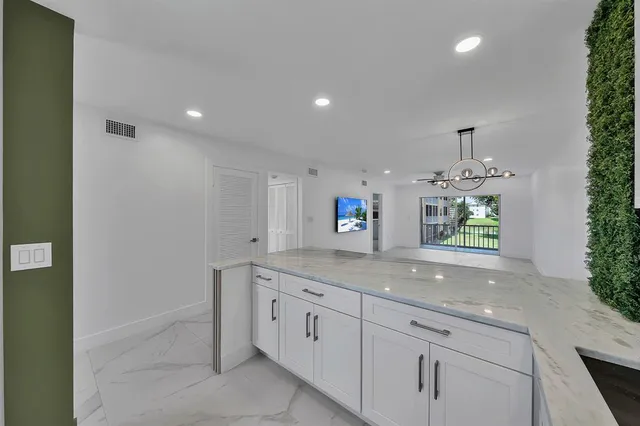 a view of a livingroom with furniture and a flat screen tv