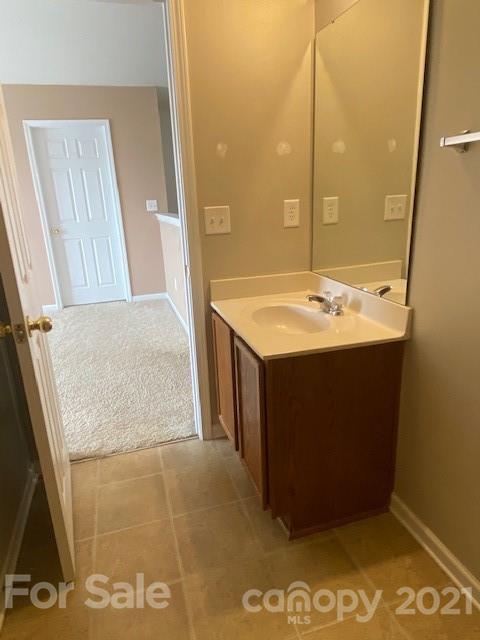 1002 Yellow Bee Road Indian Trail, NC 28079 - Photo 12 of 23 a bathroom with a sink and a mirror