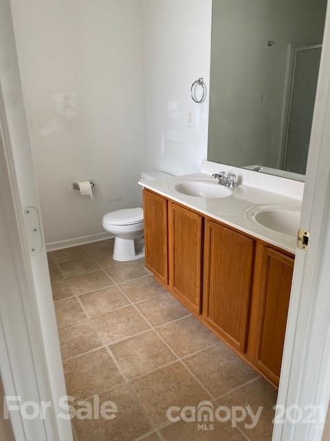 1002 Yellow Bee Road Indian Trail, NC 28079 - Photo 14 of 23 a bathroom with a sink a toilet and a mirror