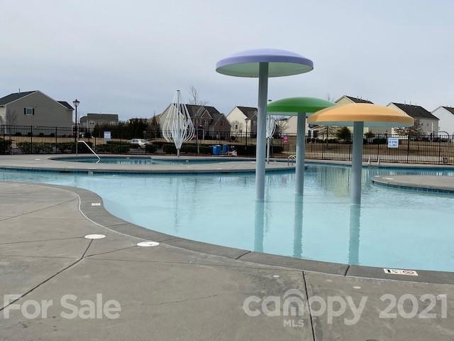 1002 Yellow Bee Road Indian Trail, NC 28079 - Photo 20 of 23 a table and chairs under an umbrella in a lake