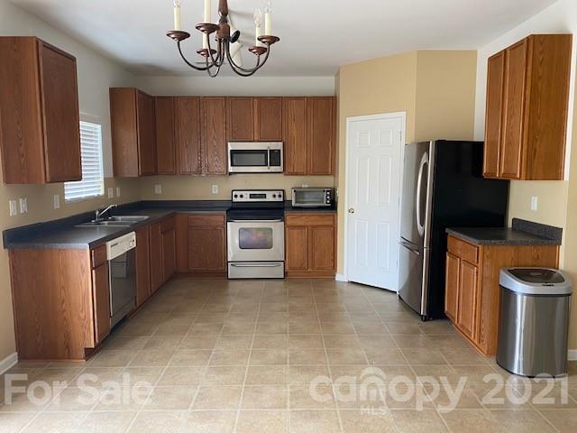 1002 Yellow Bee Road Indian Trail, NC 28079 - Photo 10 of 23 a kitchen with stainless steel appliances granite countertop a stove refrigerator and microwave