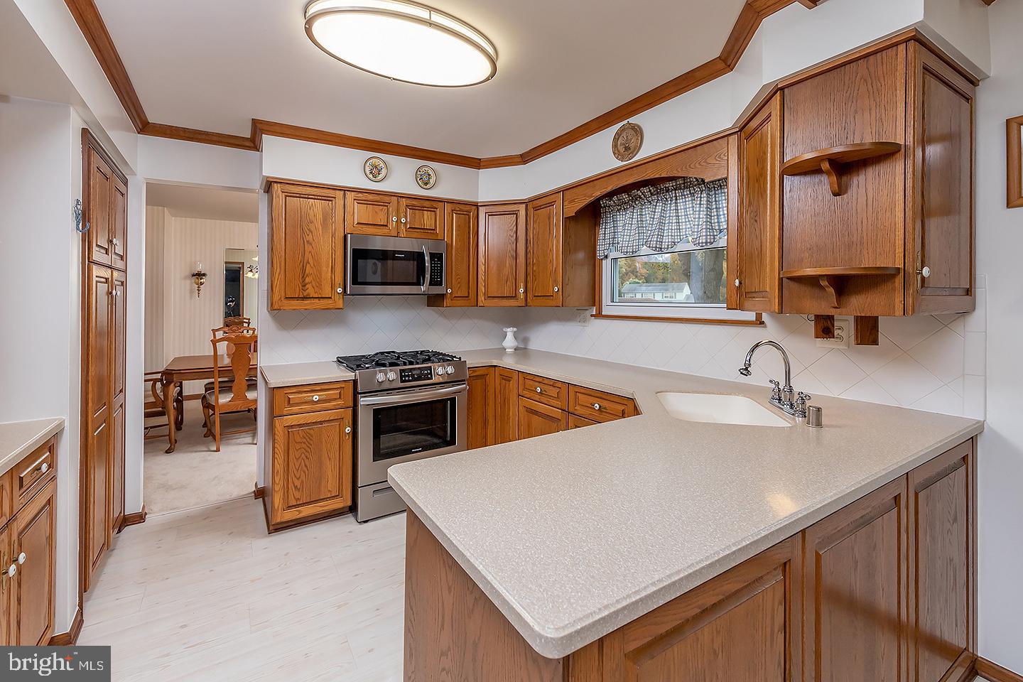 75 Freedom Road Sewell, NJ 08080 - Photo 9 of 21 a kitchen with stainless steel appliances a stove sink and a microwave