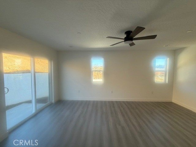 16196 Rancherias Road Apple Valley, CA 92307 - Photo 13 of 19 wooden floor in an empty room with a window