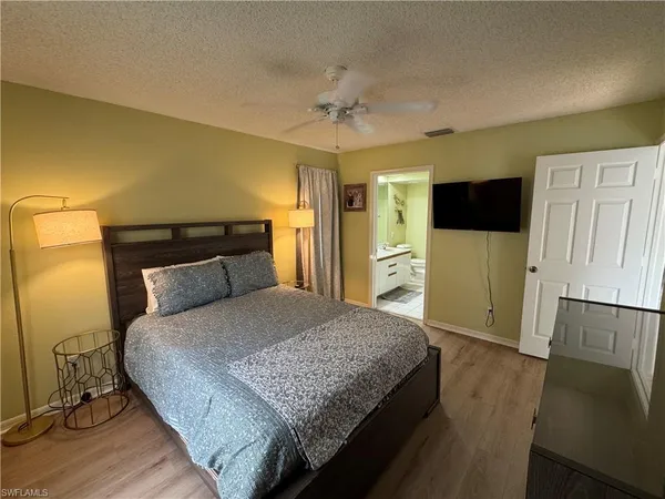 a bedroom with a bed and a flat screen tv