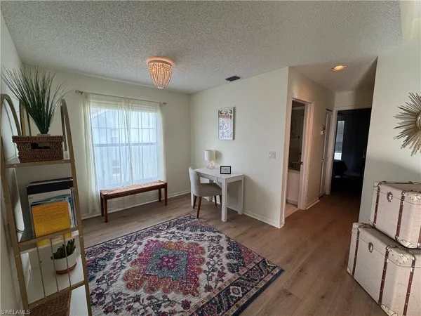 a view of a livingroom with furniture and a window