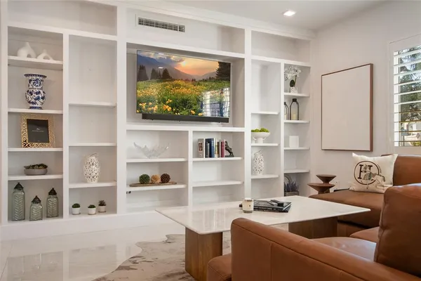 a kitchen with stainless steel appliances white cabinets and a potted plant