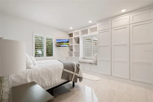 a bathroom with a sink a toilet a mirror and shower