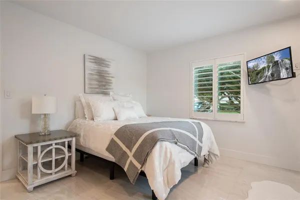 a spacious bedroom with a bed and a couch